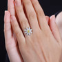 daisy flower ring with yellow sapphire and white zircon in rhodium over sterling silver worn on a hand