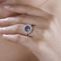quartz doublet and moissanite halo ring in rhodium over sterling silver worn on a hand
