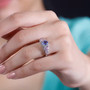 tanzanite pink sapphire and zircon halo ring in rhodium over sterling silver worn on a hand