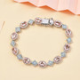 morganite blue apatite and moissanite tennis bracelet in rhodium over sterling silver shown in a lifestyle photo