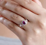 purple garnet padparadscha sapphire and zircon ring in rhodium over sterling silver worn on a hand