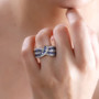 ceylon blue sapphire and white zircon crossover ring in 18k yellow gold over sterling silver worn on a hand