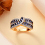 ceylon blue sapphire and white zircon crossover ring in 18k yellow gold over sterling silver shown in a lifestyle photo