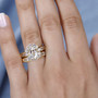 white topaz two ring bridal set in 18k yellow gold over sterling silver worn on a hand