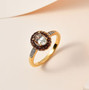 turkizite brown and white zircon halo ring in 18k yellow gold over sterling silver shown in a lifestyle photo