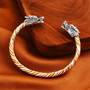 dragon head twisted two-tone cuff bracelet in 18k yellow gold and rhodium over sterling silver shown in a lifestyle photo