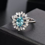blue zircon blue sapphire and moissanite ring in rhodium over sterling silver shown in a lifestyle photo