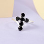 black spinel cross ring in rhodium over sterling silver shown in a lifestyle photo