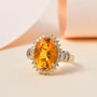 fire opal yellow and white diamond halo ring in solid 10k yellow gold shown in a lifestyle photo