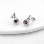 full view of dancing garnet and white zircon dangle earrings in rhodium over sterling silver