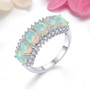 ethiopian opal six stone band ring with white zircon accents in rhodium over sterling silver shown in a lifestyle photo