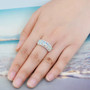 ethiopian opal six stone band ring with white zircon accents in rhodium over sterling silver worn on a hand