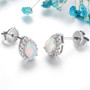 side view of pear ethiopian opal and white zircon oval halo stud earrings in rhodium over sterling silver