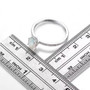 oval ethiopian opal and white zircon halo ring in rhodium over sterling silver shown for size comparison