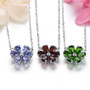 close up of garnet and white zircon flower cluster necklace in rhodium over sterling silver