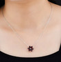 garnet and white zircon flower cluster necklace in rhodium over sterling silver worn around the neck