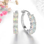ethiopian opal hoop earrings in rhodium over sterling silver shown in a lifestyle photo