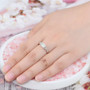 ethiopian opal and white zircon ring in rhodium over sterling silver worn on a hand