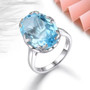 sky blue topaz solitaire ring in rhodium over sterling silver shown in a lifestyle photo
