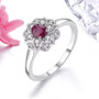 ruby and white zircon halo ring in rhodium over sterling silver shown in a lifestyle photo