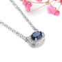 side view of blue sapphire and white zircon halo necklace in rhodium over sterling silver