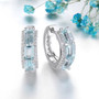 front view of aquamarine and white zircon hoop earrings in rhodium over sterling silver