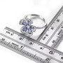 tanzanite and white zircon flower ring in rhodium over sterling silver shown for size comparison