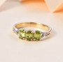 sphene and diamond trilogy ring in solid 10k yellow gold shown in a lifestyle photo