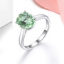 green fluorite 10x8mm oval solitaire ring in rhodium over sterling silver shown in a lifestyle photo
