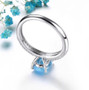 back view of swiss blue topaz and white zircon solitaire ring in rhodium over sterling silver