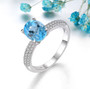 swiss blue topaz and white zircon solitaire ring in rhodium over sterling silver shown in a lifestyle photo
