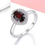 garnet and white zircon halo ring in rhodium over sterling silver shown in a lifestyle photo