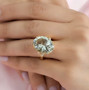 prasiolite and white topaz cocktail ring in 18k yellow gold over sterling silver worn on a hand