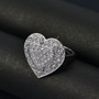 lab grown diamond heart ring in rhodium over sterling silver shown in a lifestyle photo