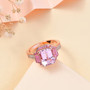 kunzite pink sapphire and zircon three stone halo ring in 18k rose gold over sterling silver shown in a lifestyle photo