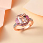 morganite pink sapphire and zircon three stone halo ring in 18k rose gold over sterling silver shown in a lifestyle photo