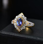 tanzanite yellow sapphire and moissanite halo ring in 18k yellow gold over sterling silver shown in a lifestyle photo