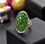 chrome diopside pink tourmaline and white zircon cluster halo ring in rhodium over sterling silver shown in a lifestyle photo