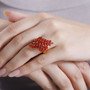 fire opal bypass ring in 18k yellow gold over sterling silver worn on a hand