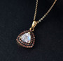 rainbow moonstone and brown zircon double halo pendant necklace in 18k yellow gold over sterling silver shown in a lifestyle photo