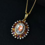 rainbow moonstone and multi gemstone halo pendant necklace in 18k yellow gold over sterling silver shown in a lifestyle photo