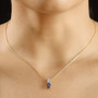 tanzanite and moissanite pendant necklace in 18k yellow gold over sterling silver worn around the neck