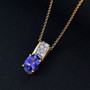 tanzanite and moissanite pendant necklace in 18k yellow gold over sterling silver shown in a lifestyle photo