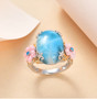 larimar shell and blue apatite flower ring in two-tone 18k yellow gold and rhodium over sterling silver shown in a lifestyle photo