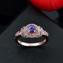 tanzanite pink sapphire and zircon ring in 18k rose gold over sterling silver shown in a lifestyle photo