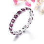 rhodolite garnet eternity band ring in rhodium over sterling silver shown in a lifestyle photo