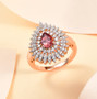 blush garnet and moissanite pear halo ring in 18k rose gold over sterling silver shown in a lifestyle photo