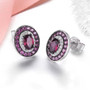 side view of rhodolite garnet and white zircon stud earrings in black and white rhodium over sterling silver