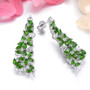 side view of chrome diopside and white zircon dangle earrings in rhodium over sterling silver