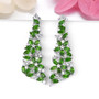 chrome diopside and white zircon dangle earrings in rhodium over sterling silver shown in a lifestyle photo